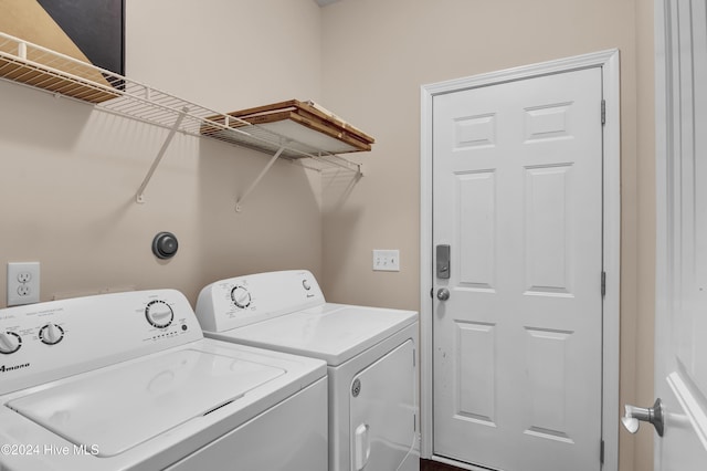 washroom with washing machine and clothes dryer