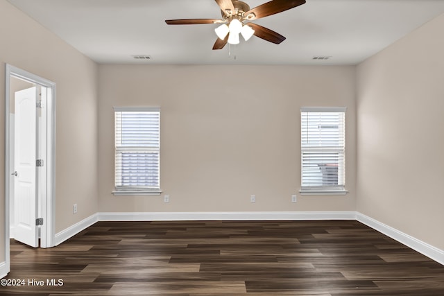 unfurnished room with ceiling fan, a healthy amount of sunlight, and dark hardwood / wood-style floors