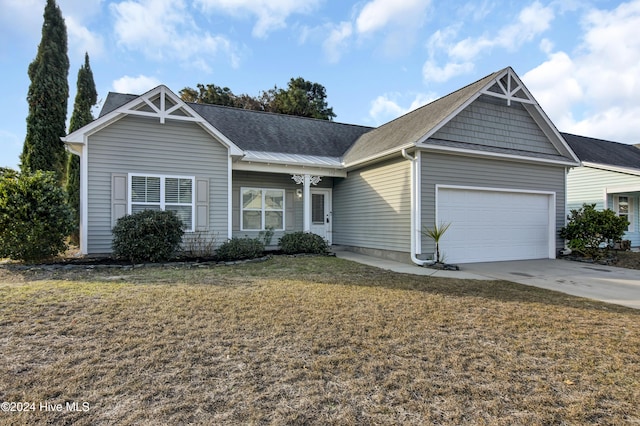 view of front of property with a garage and a front yard