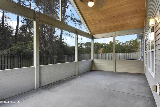 unfurnished sunroom featuring a wealth of natural light, wood ceiling, and lofted ceiling