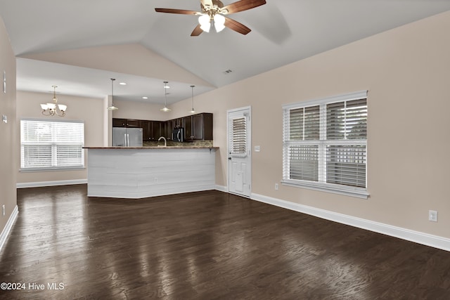 unfurnished living room with ceiling fan with notable chandelier, dark hardwood / wood-style flooring, and lofted ceiling