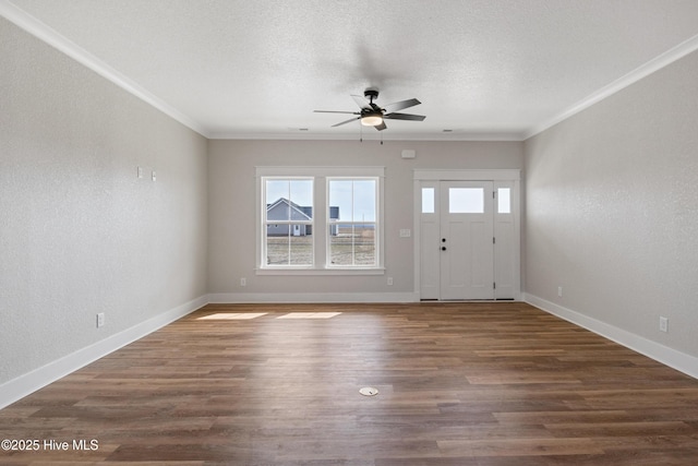 entryway with ornamental molding, a textured ceiling, baseboards, and wood finished floors