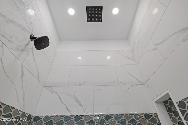 interior details featuring recessed lighting and a tile shower