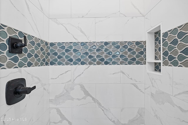 full bathroom with a tile shower