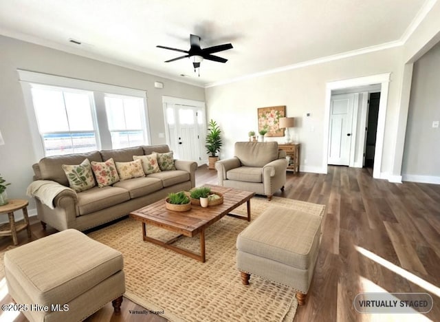 living area featuring ornamental molding, dark wood-type flooring, a ceiling fan, and baseboards