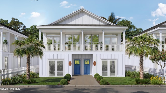 view of front of house with a front yard and a balcony