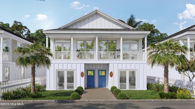 820 Kenneth Ave Unit 1, Carolina Beach, NC 28428 - view of front of house with board and batten siding, fence, and a balcony