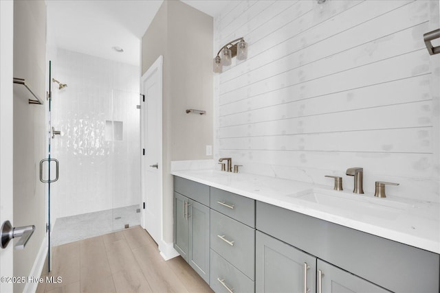 820 Kenneth Ave Unit 1, Carolina Beach, NC 28428 - bathroom with a shower stall, a sink, and wood finished floors