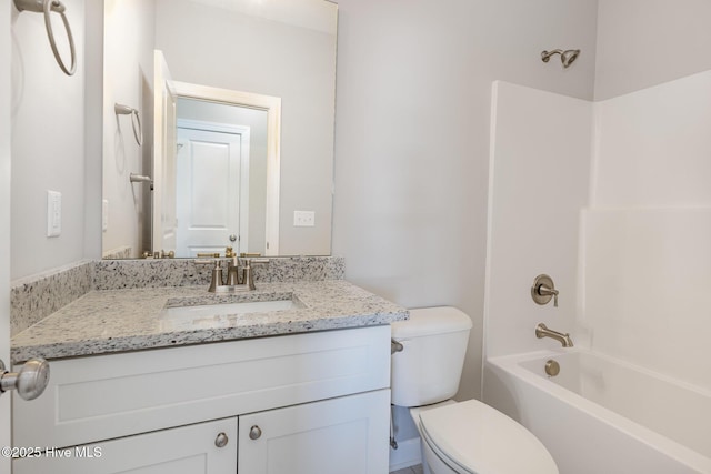 full bathroom featuring toilet, vanity, and bathtub / shower combination