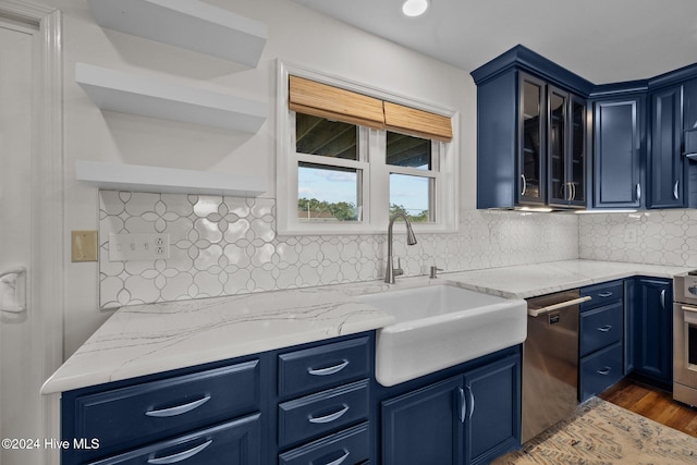 kitchen with decorative backsplash, dark hardwood / wood-style flooring, blue cabinetry, and appliances with stainless steel finishes