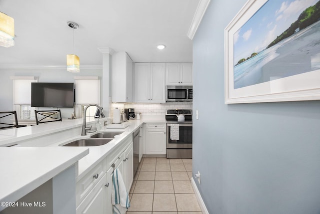 209 Hillside Dr N Unit 201, North Myrtle Beach, SC 29582 - kitchen with stainless steel appliances, ornamental molding, backsplash, white cabinets, and light tile patterned flooring