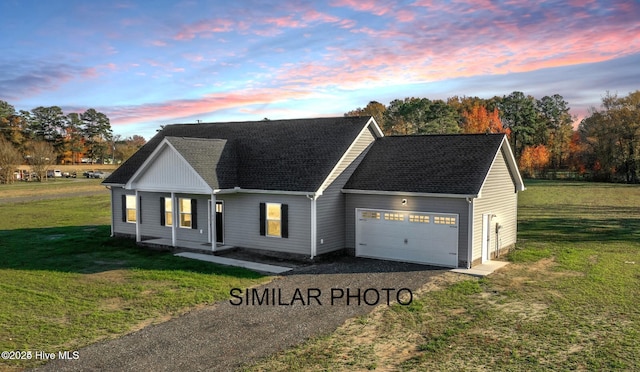 view of front of property featuring a garage and a yard