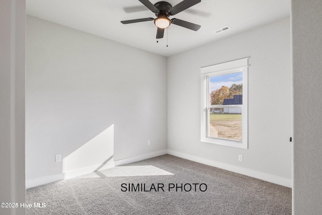 carpeted spare room with ceiling fan