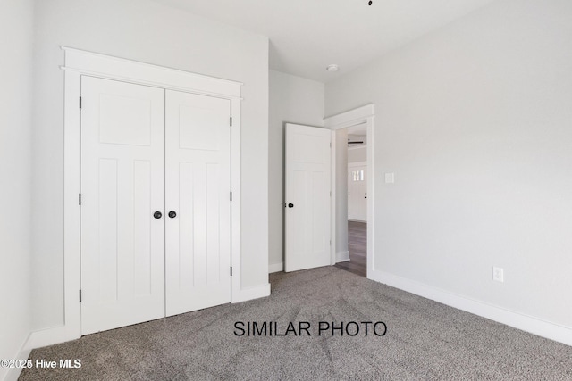 unfurnished bedroom with carpet floors and a closet