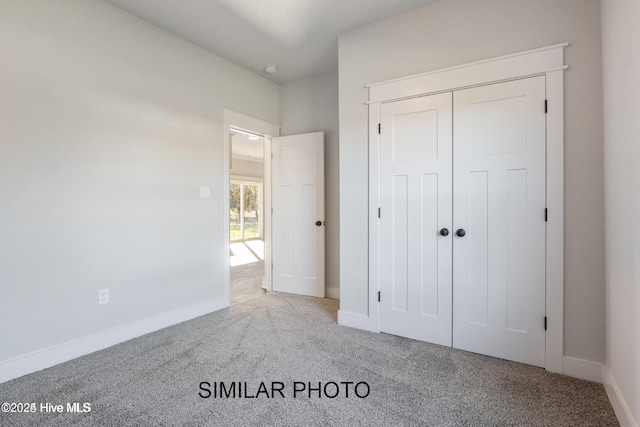 unfurnished bedroom with carpet floors and a closet