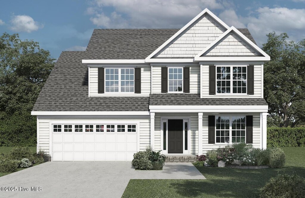view of front of property with a front yard and a garage