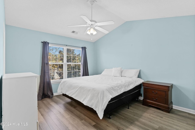 bedroom with hardwood / wood-style floors, ceiling fan, and lofted ceiling