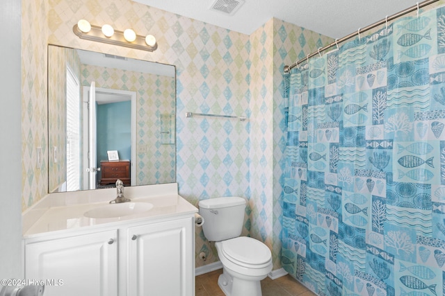 bathroom featuring vanity, tile patterned floors, a shower with curtain, toilet, and a textured ceiling