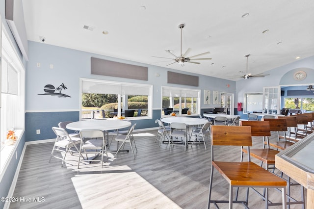 dining area with ceiling fan, french doors, and wood-type flooring