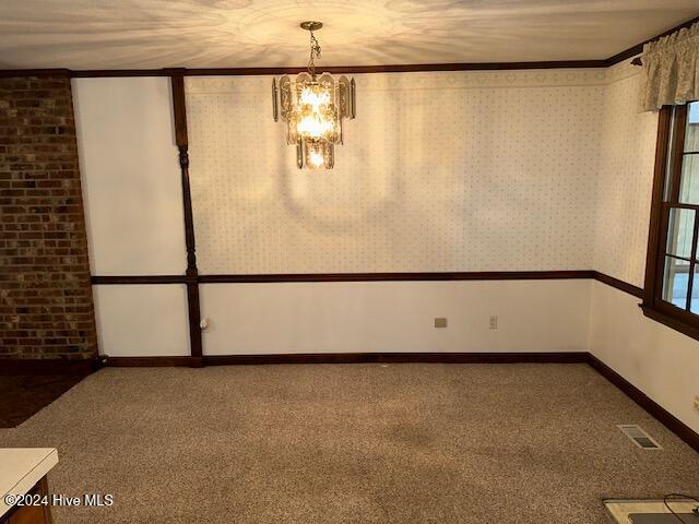1738 NC-306 Hwy S, Grantsboro, NC 28529 - carpeted spare room with a chandelier, baseboards, and crown molding