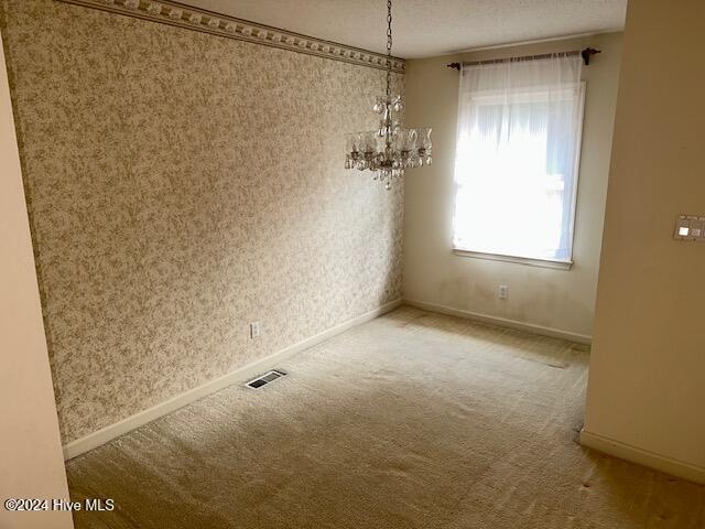 1738 NC-306 Hwy S, Grantsboro, NC 28529 - unfurnished dining area with carpet floors, a chandelier, and baseboards