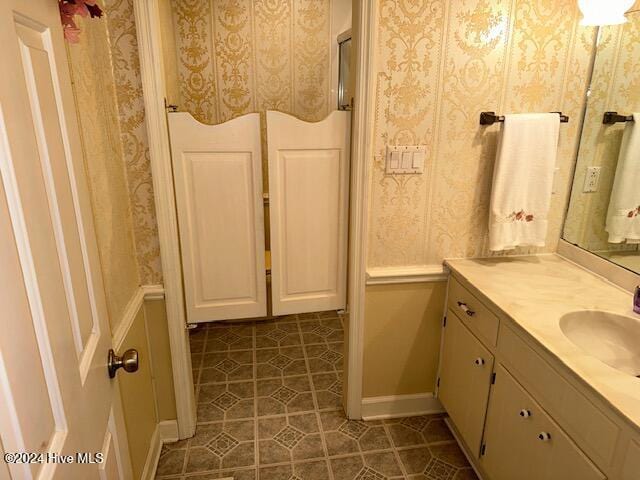 1738 NC-306 Hwy S, Grantsboro, NC 28529 - full bath featuring vanity, baseboards, wallpapered walls, and tile patterned flooring