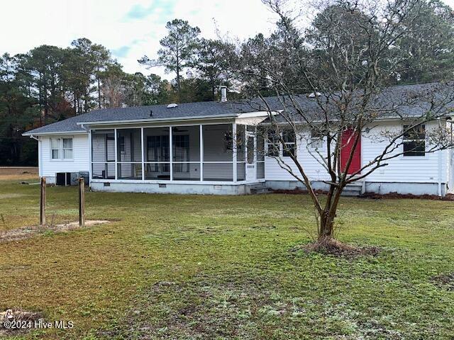 1738 NC-306 Hwy S, Grantsboro, NC 28529 - rear view of house with a yard, a sunroom, and central air condition unit