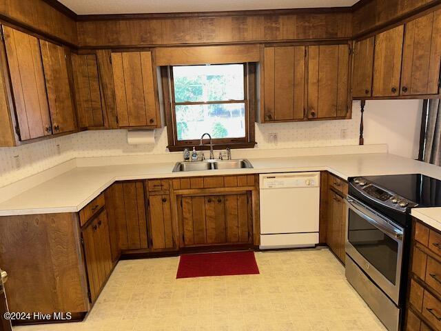 1738 NC-306 Hwy S, Grantsboro, NC 28529 - kitchen with dishwasher, a sink, electric range, light floors, and light countertops