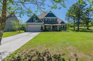 view of front of house with a garage and a front yard