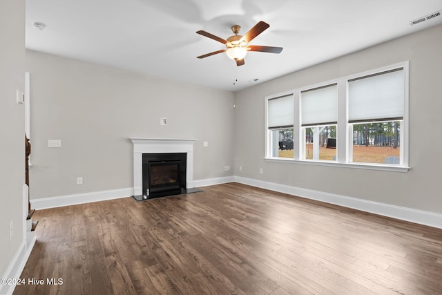 unfurnished living room with ceiling fan and dark hardwood / wood-style floors