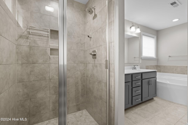 bathroom with tile patterned floors, vanity, and independent shower and bath