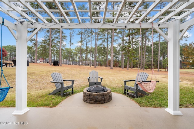 view of community featuring a yard, a pergola, and an outdoor fire pit