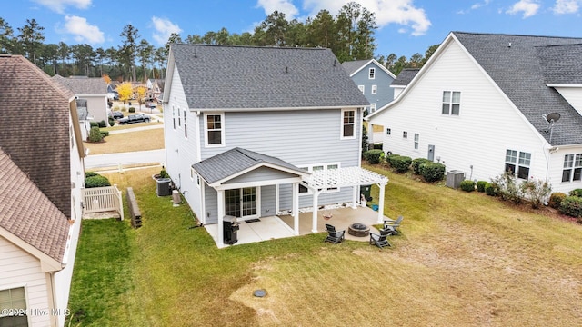 rear view of house featuring central AC unit, a patio area, and a yard