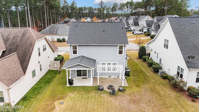 back of house featuring a lawn, cooling unit, and a patio