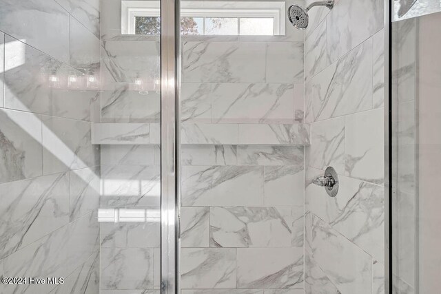 bathroom with plenty of natural light and a tile shower