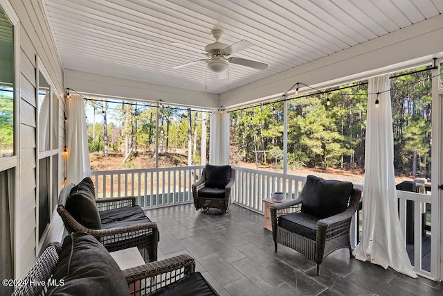 sunroom with ceiling fan and wood ceiling