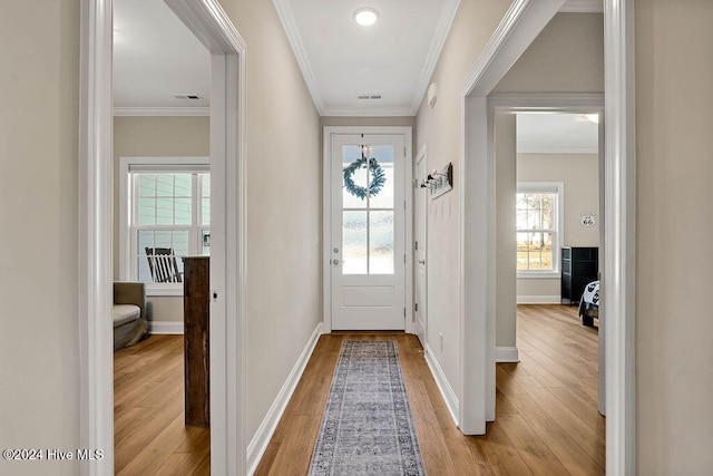 doorway featuring crown molding and light hardwood / wood-style flooring