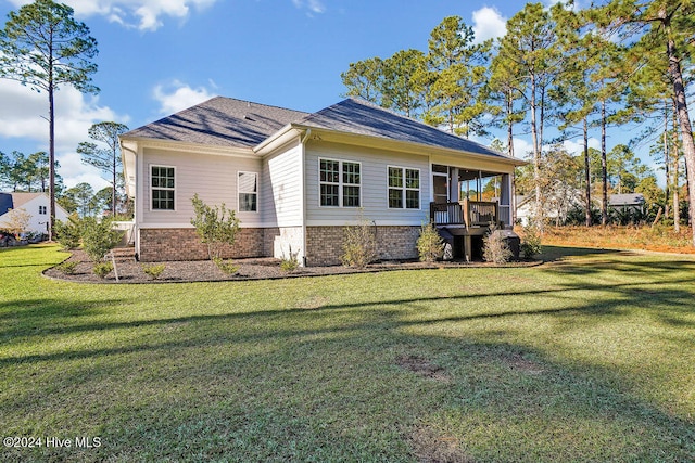 rear view of property with a yard