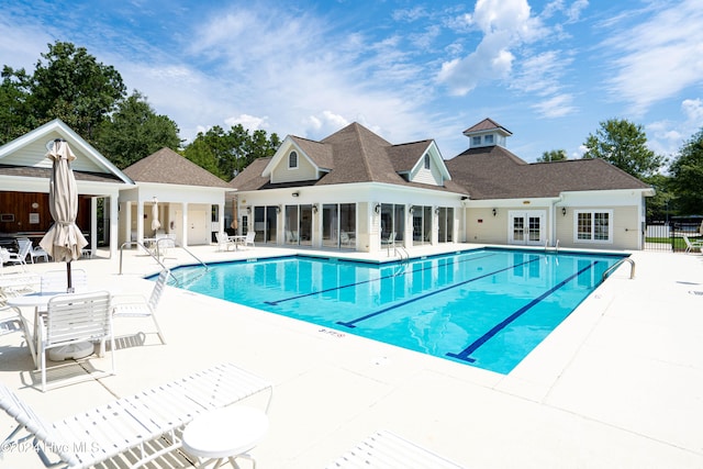 view of swimming pool featuring a patio and french doors