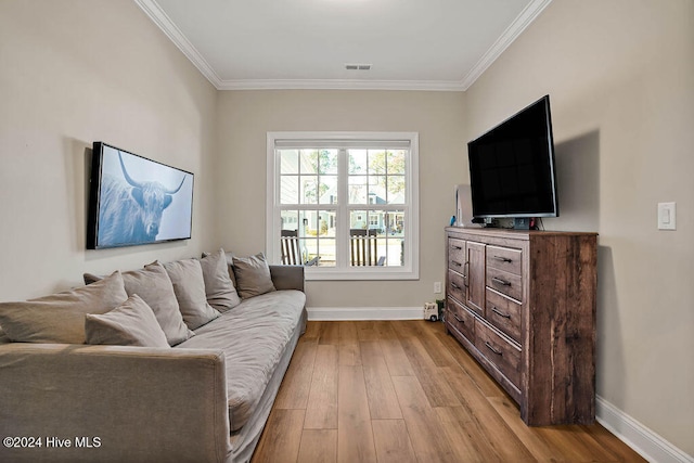 living room with crown molding and light wood-type flooring