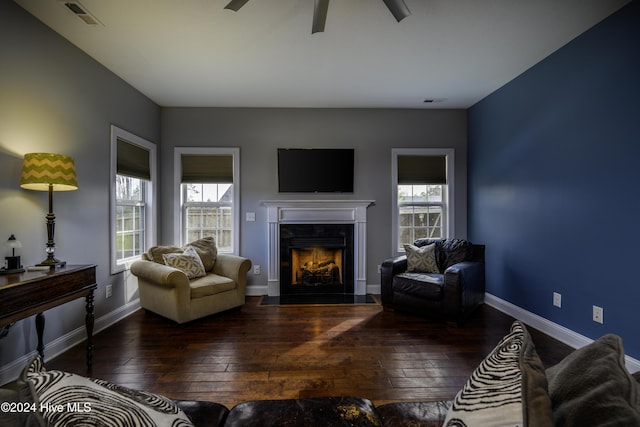 living room featuring ceiling fan and dark wood-type flooring