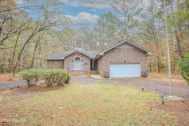 view of front facade featuring a front lawn and a garage