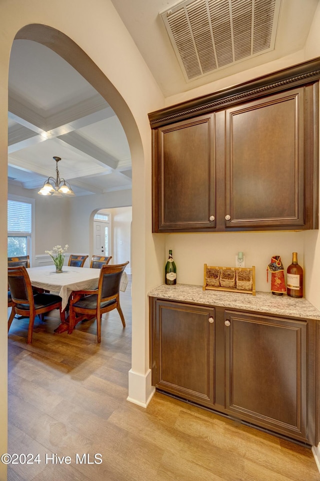 270 Hydrangea Ln, Hampstead, NC 28443 - bar with arched walkways, coffered ceiling, light wood-type flooring, beam ceiling, and a chandelier