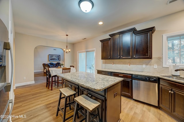 270 Hydrangea Ln, Hampstead, NC 28443 - kitchen with appliances with stainless steel finishes, arched walkways, a chandelier, a sink, and a kitchen breakfast bar