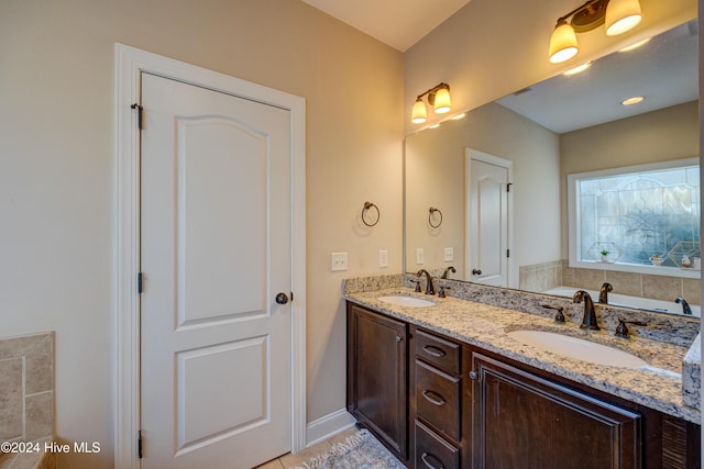 270 Hydrangea Ln, Hampstead, NC 28443 - bathroom featuring double vanity, baseboards, and a bath