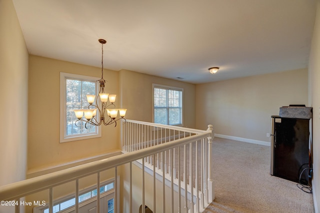 270 Hydrangea Ln, Hampstead, NC 28443 - corridor featuring an upstairs landing, a chandelier, carpet, and baseboards