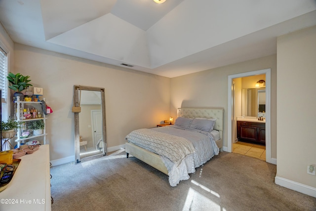 270 Hydrangea Ln, Hampstead, NC 28443 - carpeted bedroom featuring a raised ceiling, baseboards, and ensuite bathroom
