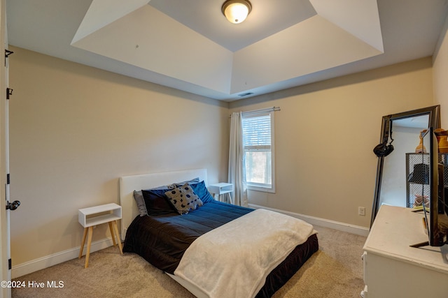 270 Hydrangea Ln, Hampstead, NC 28443 - bedroom featuring light carpet, a tray ceiling, and baseboards