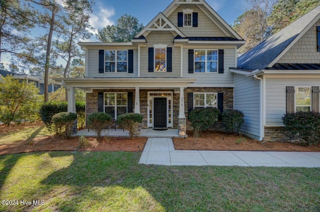 270 Hydrangea Ln, Hampstead, NC 28443 - craftsman house with a porch, a standing seam roof, and a front lawn