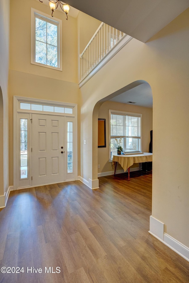 270 Hydrangea Ln, Hampstead, NC 28443 - foyer entrance featuring arched walkways, wood finished floors, baseboards, and a towering ceiling